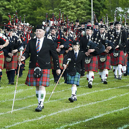 Pipe bands marching at highland games